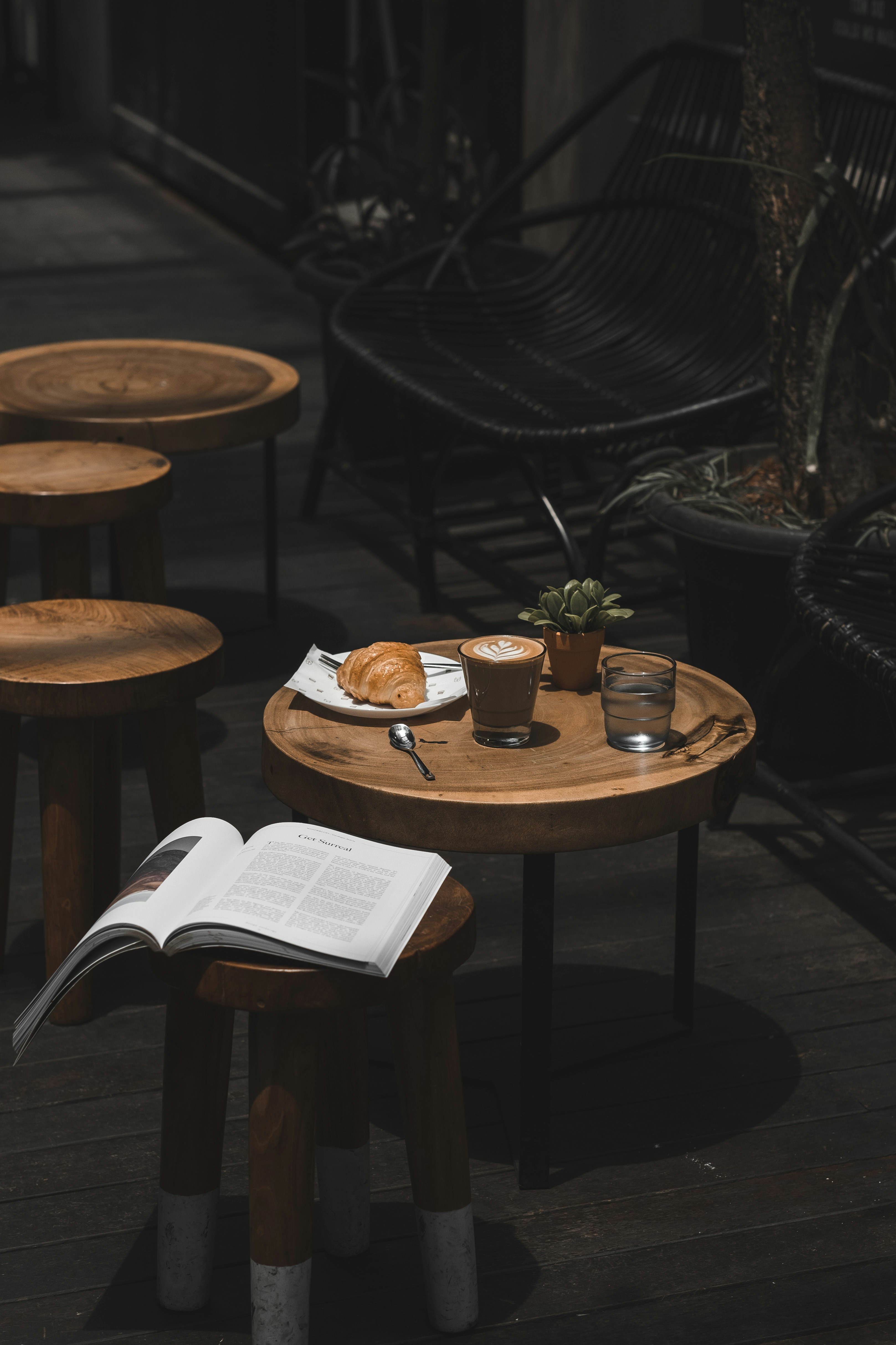 Linger Singapore — a cortado and an open book on a sunlit timber deck