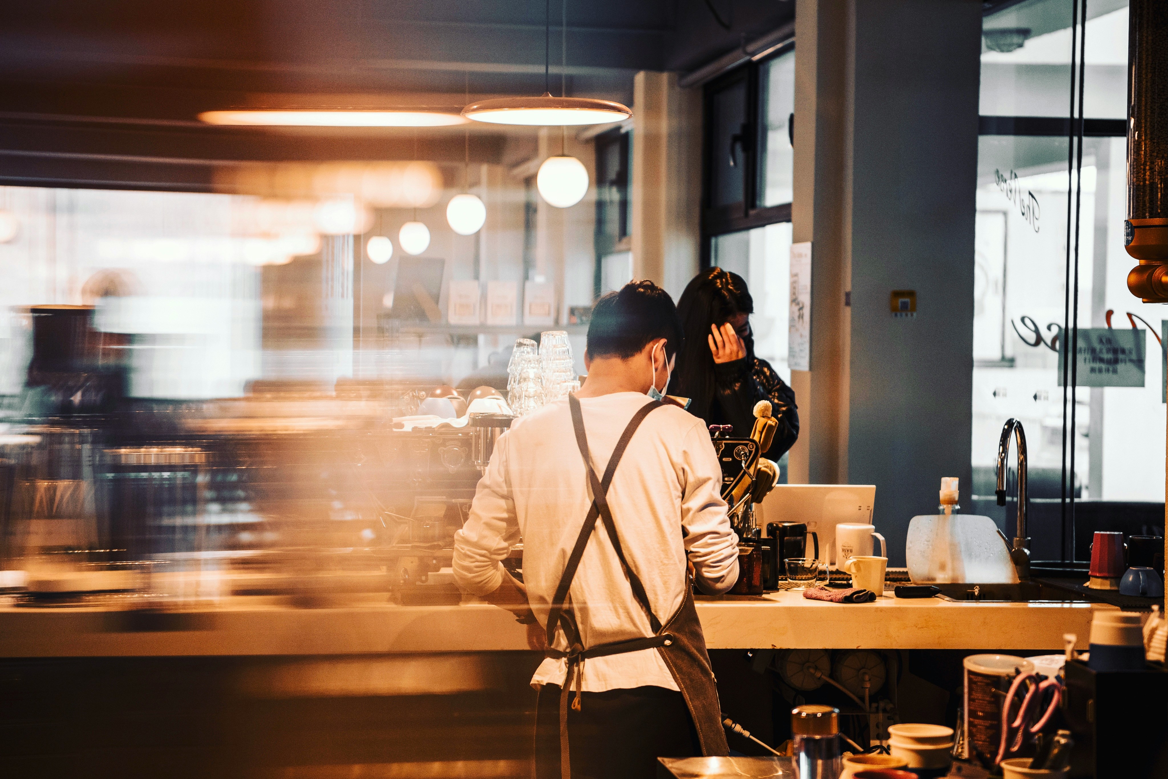 Linger Hong Kong — a barista at the bar in a bright morning blur
